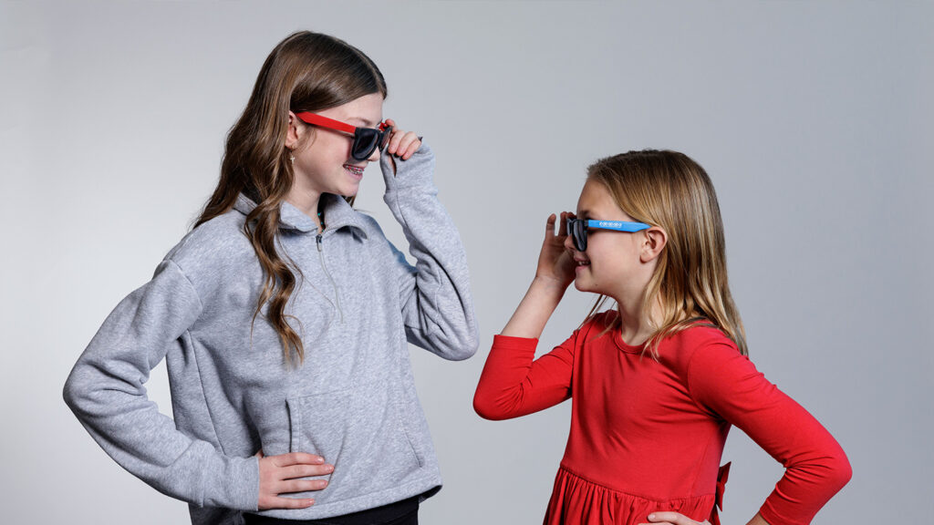 two school student girls smile as orthodontic patients